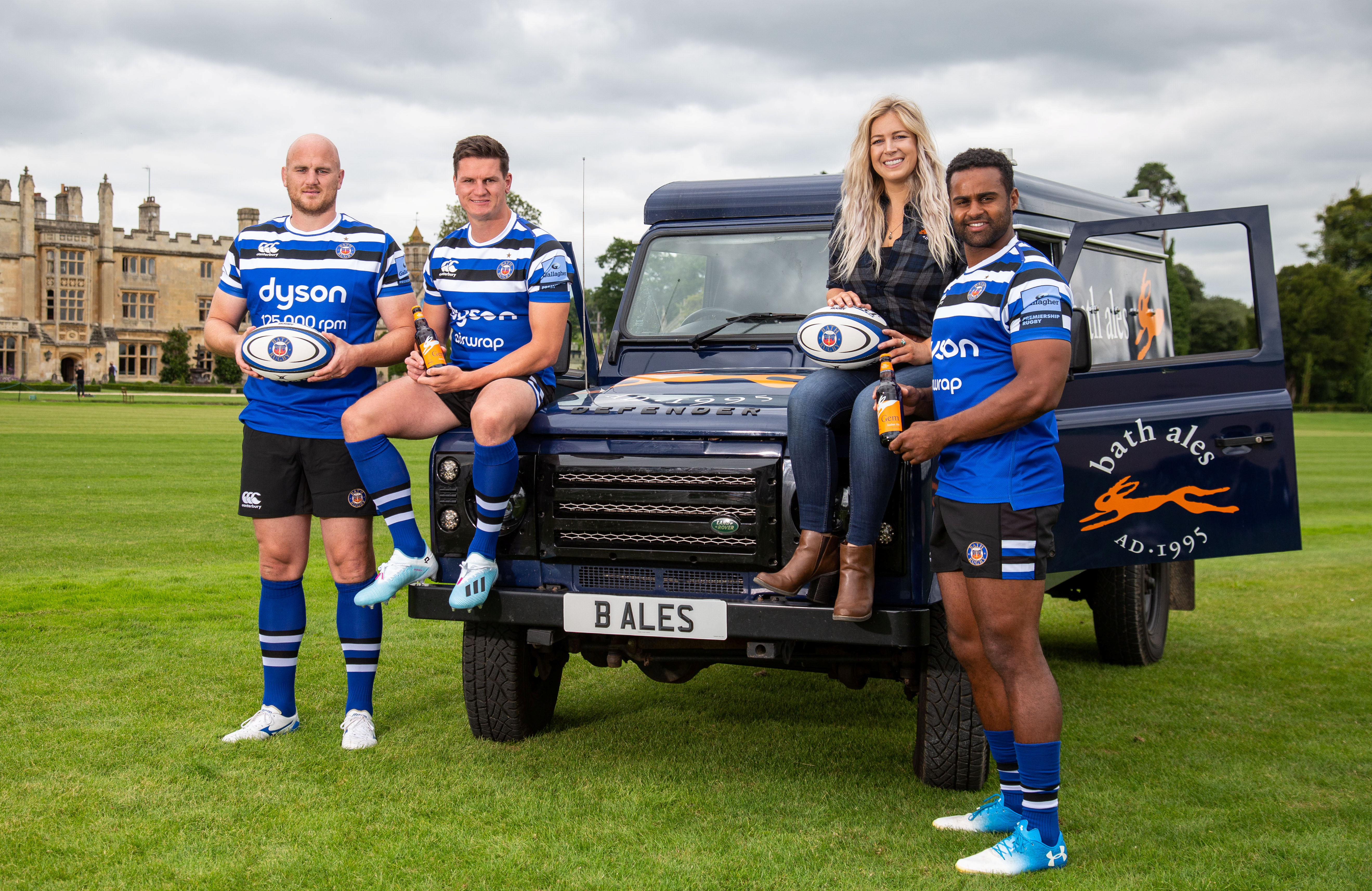 St Austell Brewery - Bath Rugby players Matt Garvey (left), Freddie Burns (centre) and Aled Brew with Vicky Guy, Bath Ales Marketing Manager and the Bath Ales Land Rover to celebrate the renewed sponsorship of the club. Bath, Somerset. August 22 2019.